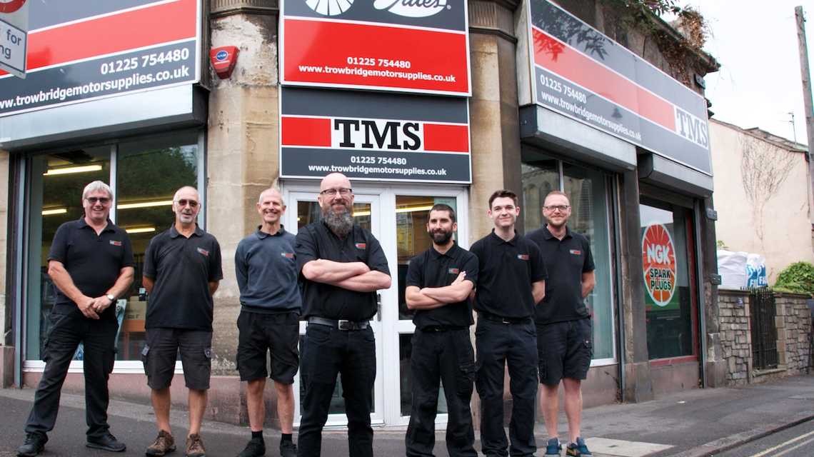 TMS team standing outside the shop